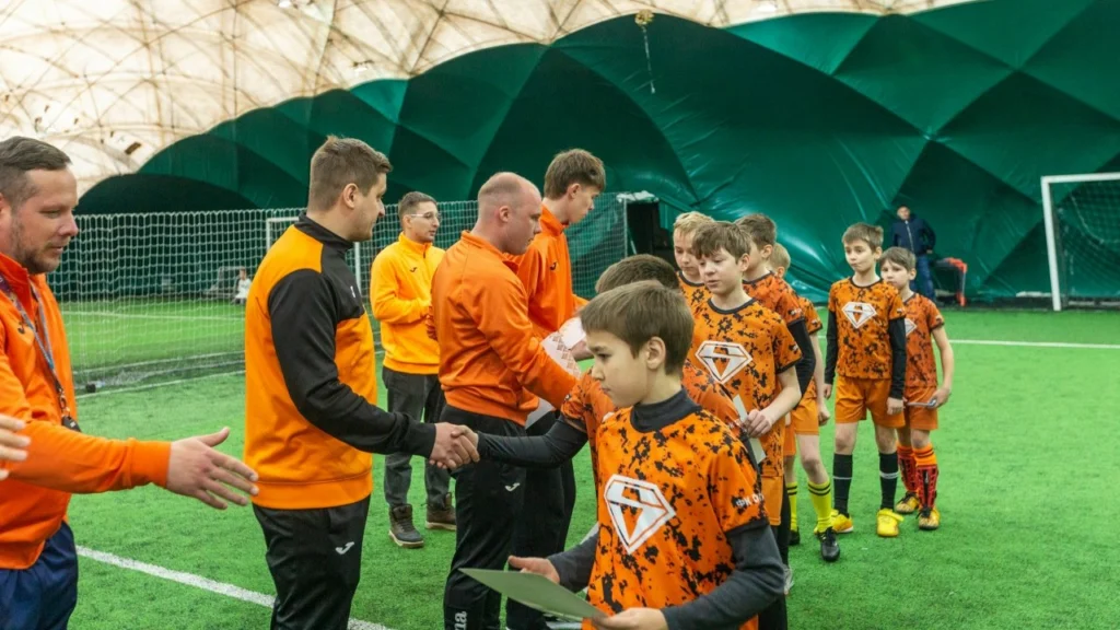 Тренер «Спектра» поздравляет ребёнка на награждении